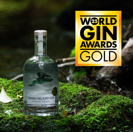 Bottle of Third Island Gin on a natural background with World Gin Awards Gold logo.