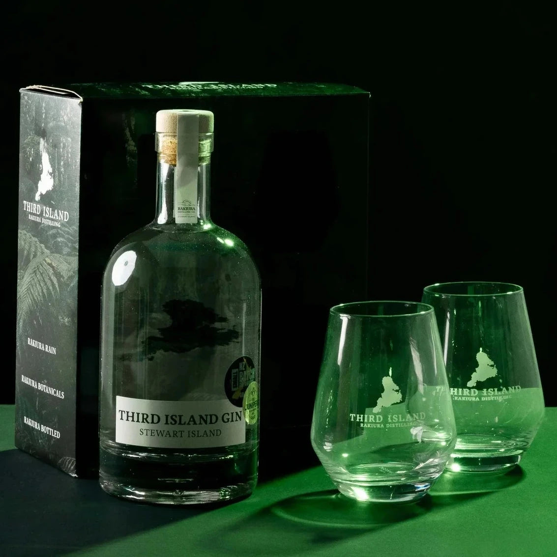 Third Island Gift Box with bottle of Third Island Gin with two glasses on a green surface against a black background