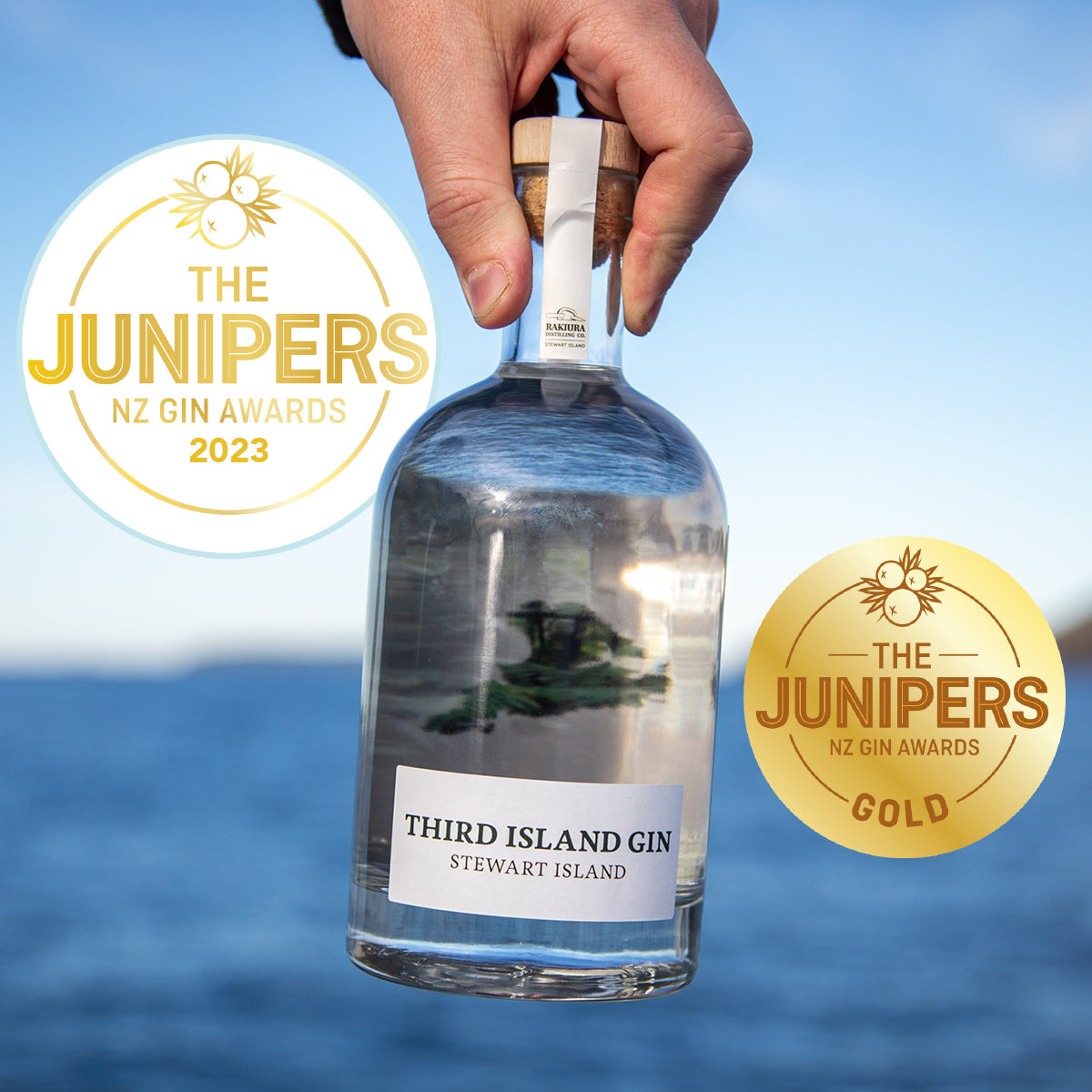 Bottle of Third Island Gin with 'The Junipers NZ Gin Awards 2023' and gold award badge on a blue background