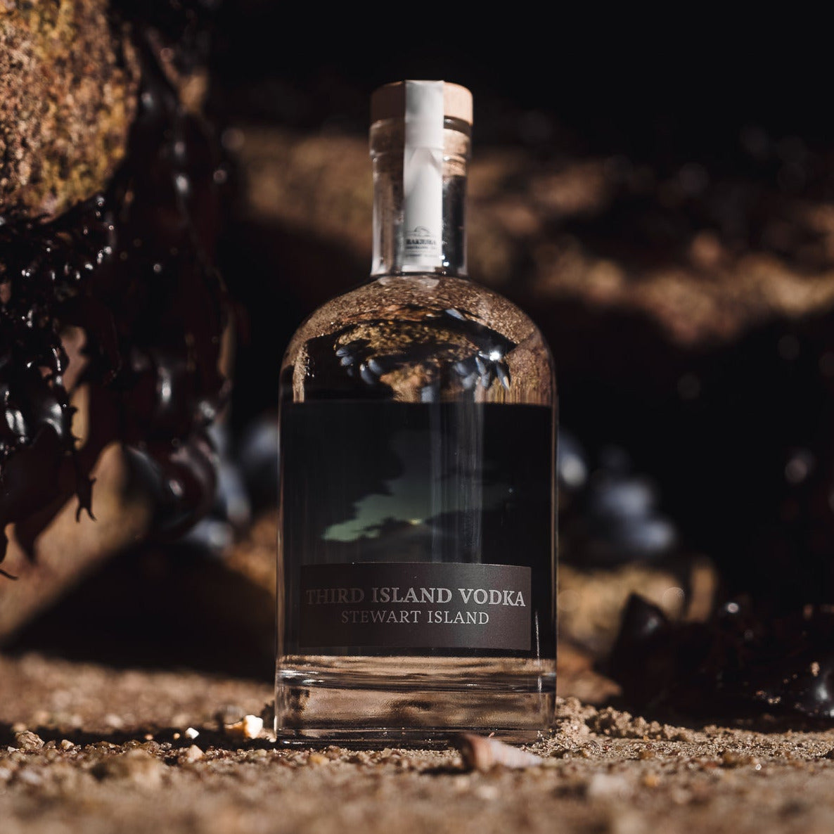 Bottle of Third Island Vodka on a natural background